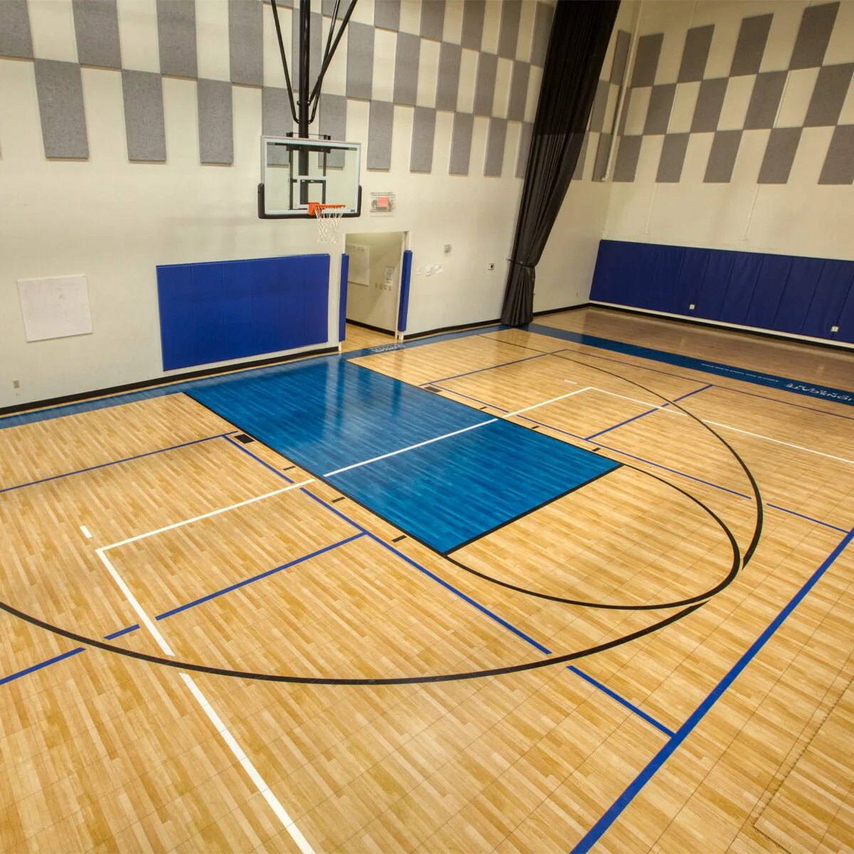 Indoor gymnasium featuring a ceiling suspended basketball hoop and Maple Select flooring