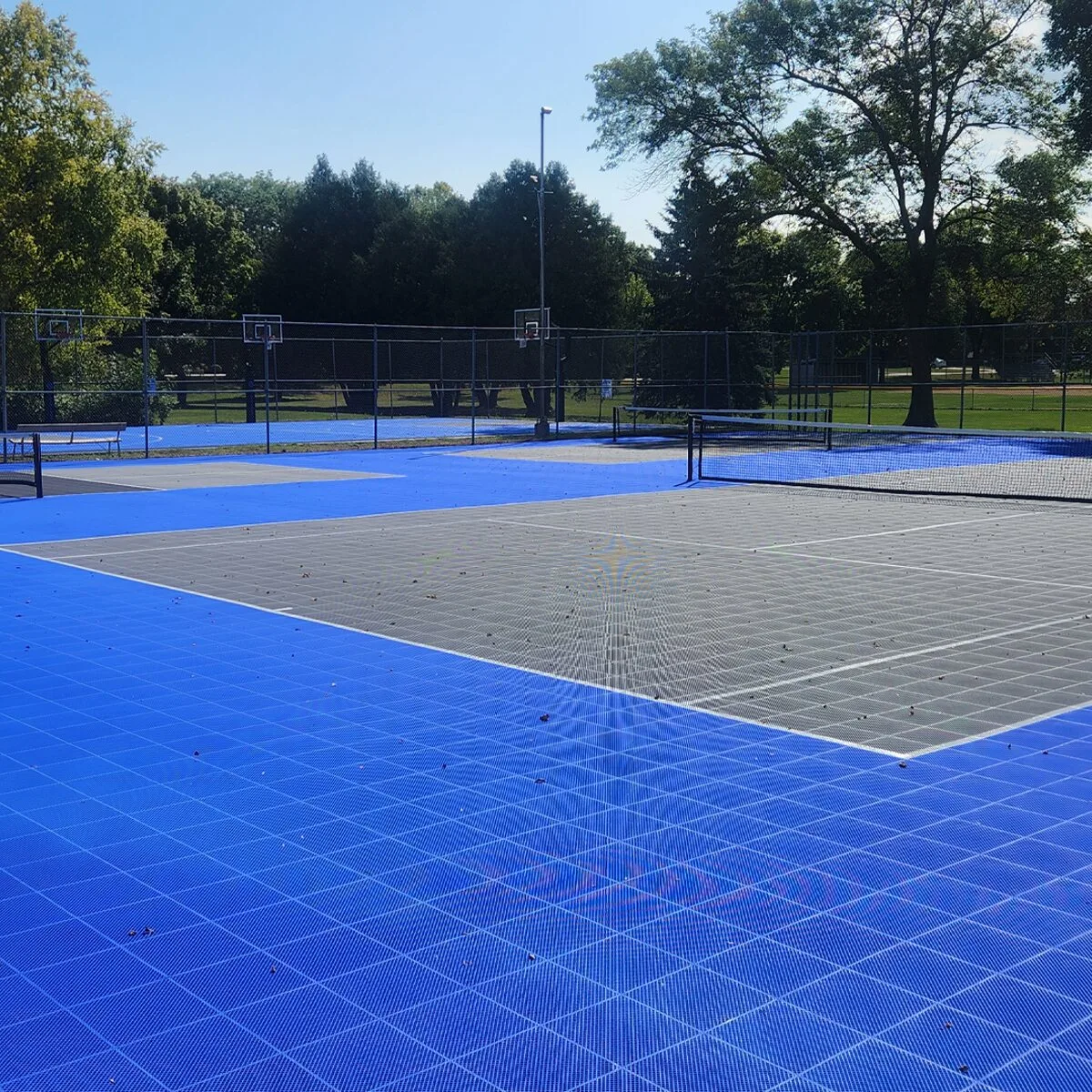 Outdoor multi-sport court in a park setting on a sunny day