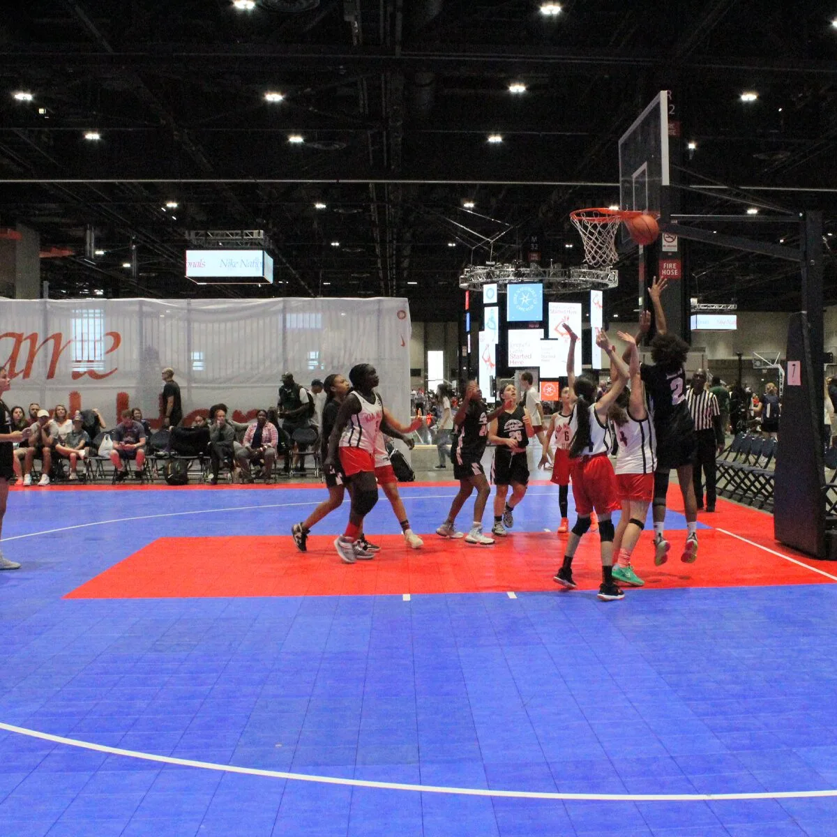 Women's basketball teams throwing a basketball into a hoop during a basketball event